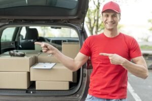 Delivery driver with packages in car trunk