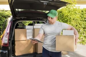 Man and van driver loading boxes for a local move in Manchester