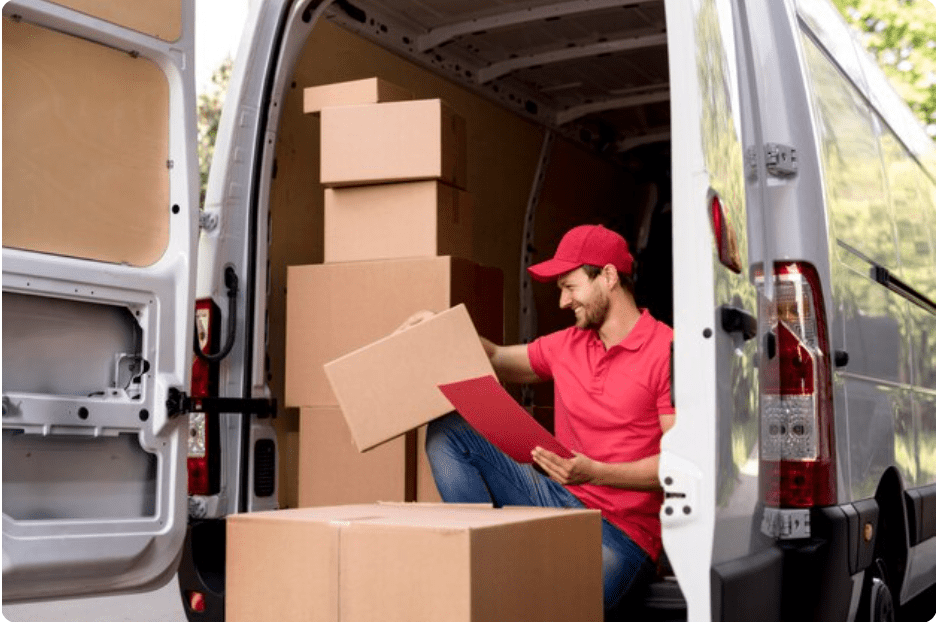 Mover organizing relocation boxes in delivery van