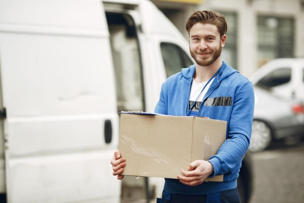 Professional mover carrying box during house relocation